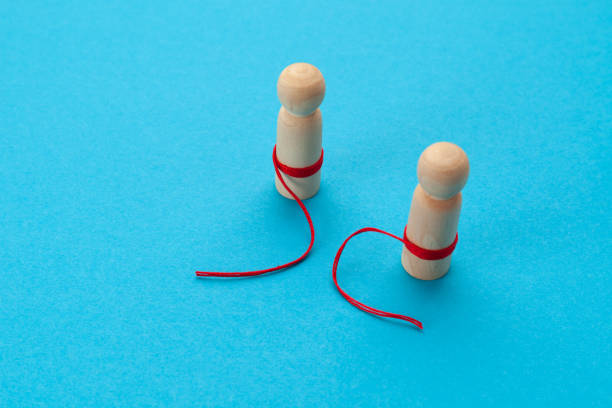 istock Two figures with a broken red thread. Breakup in relationships, family problems. Divorce concept 1304767647