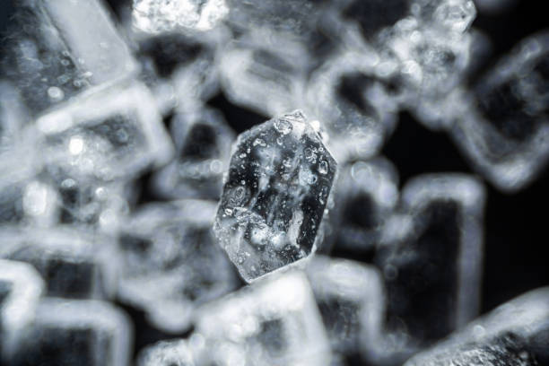 istock Crystal sugar close up on black background under the light microscope with a magnification of 40 times 1304768702
