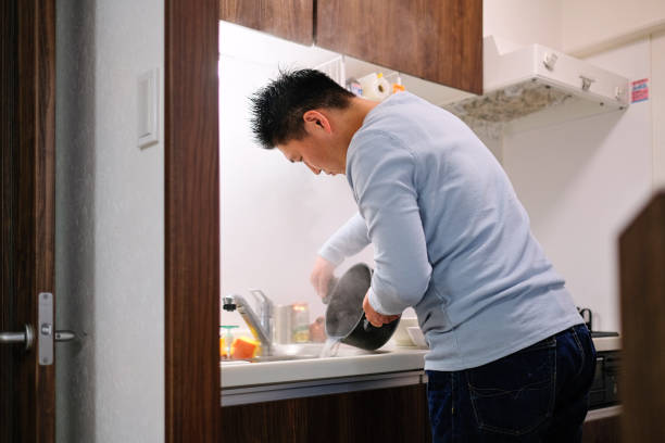 istock Mid adult man cooking in domestic kitchen 1304768769