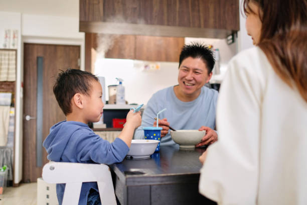 istock Father, mother, and son eating lunch together 1304768794