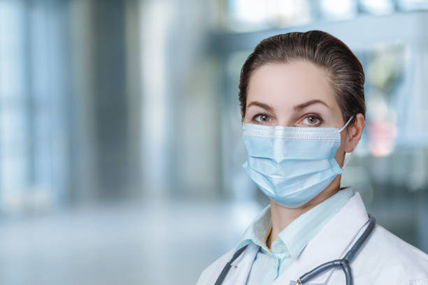 istock Doctor in a protective mask stands . 1304769780