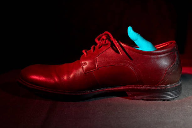 istock Surreal looking image, men's shoe with a hand inside 1304770284