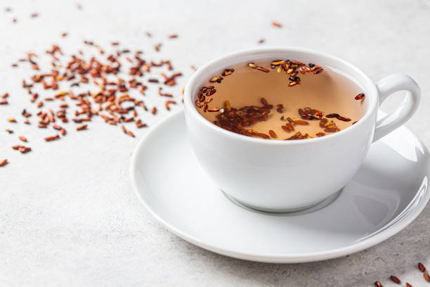 Brown rice tea in white cup, copy space.