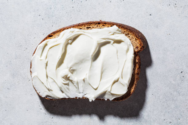 istock Cream cheese toast on gray background, top view. Minimalism concept. 1304771438