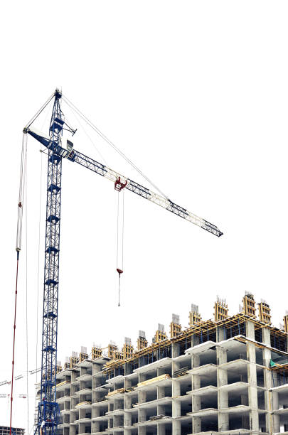 istock Low angle view on construction site residential building with a crane, isolated at white background 1304772621