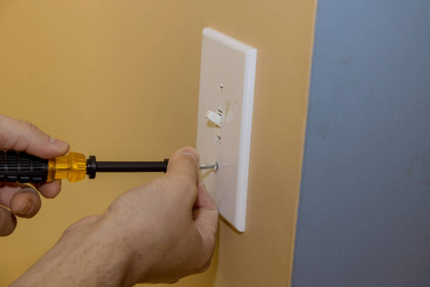 istock Removing white light switch cover plastic on preparation wall for new paint wall 1304773432