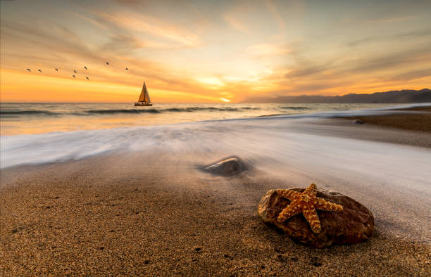 istock Sunset Sailboat Surreal Ocean Beach Fantasy 1304774967