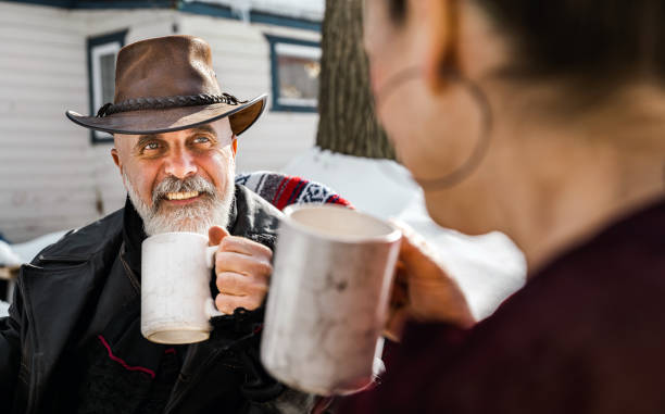 istock Senior couple enjoying hot drinks at the cottage 1304775006