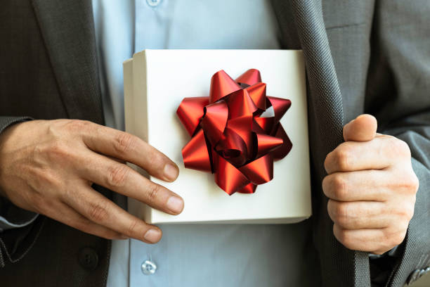istock Businessman giving Gift Box 1304775084