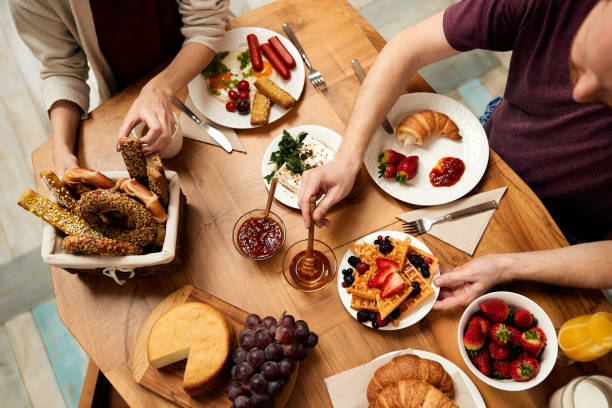 istock Above view of a couple eating breakfast at dining table. 1304775116