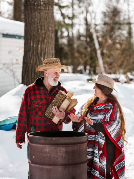 istock Senior couple by the fire pit at the cottage 1304775242