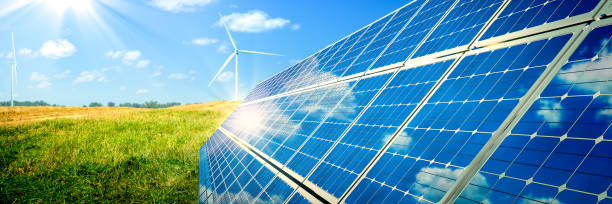 Solar Panels And Wind Turbines Solar Panels And Wind Turbines In Grassy Field With Sunlight - Renewable Energy Concept alternative energy stock pictures, royalty-free photos & images