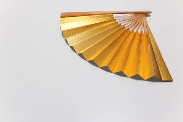 istock golden Japanese fan in a white background 1304776031
