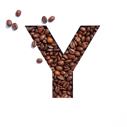 Letter Y of English alphabet made of coffee beans and paper cut isolated on white. Typeface for coffee store. High quality photo