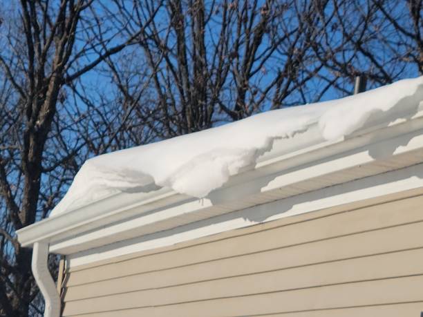 istock Snow piled on roof and hanging over 1304776056