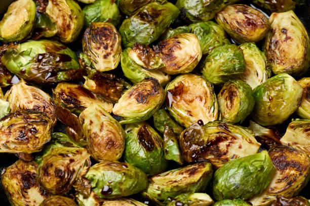 Roasted Brussel sprouts in cast iron pan Roasted Brussel sprouts in cast iron pan roasted stock pictures, royalty-free photos & images