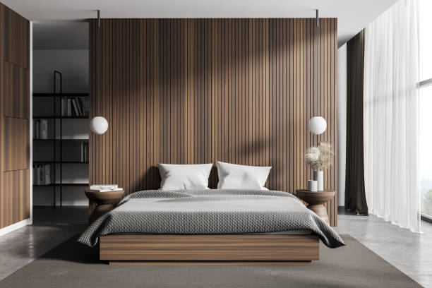 Wooden master bedroom interior with bookcase Interior of master bedroom with wooden walls, concrete floor, comfortable king size bed and bookcase in the background. 3d rendering owner's bedroom stock pictures, royalty-free photos & images