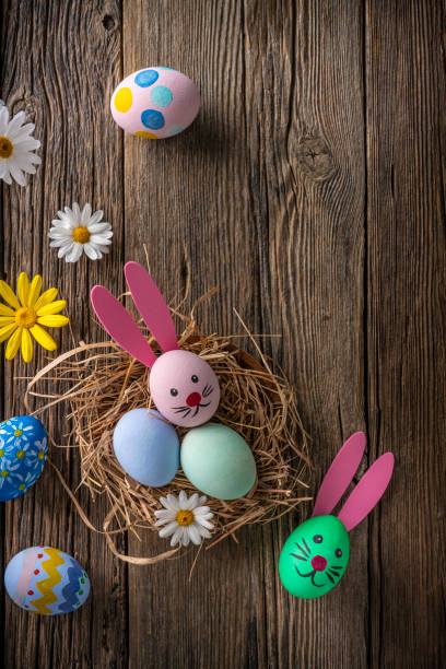 istock Easter eggs on a nest hand painted over rustic wood 1304782136