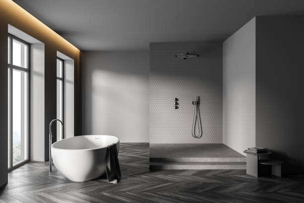 istock Gray bathroom interior with tub and shower stall 1304783491