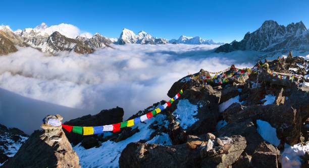 mount Everest Makalu Lhotse with buddhist prayer flags view from Gokyo Ri to mounts Everest Makalu and Lhotse with buddhist prayer flags, trek to Everest base camp and three passes trek, Nepal himalayas mountains base camp stock pictures, royalty-free photos & images