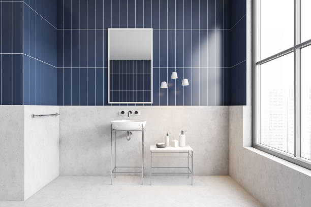 istock White and blue bathroom with one sink, mirror and window 1304785646
