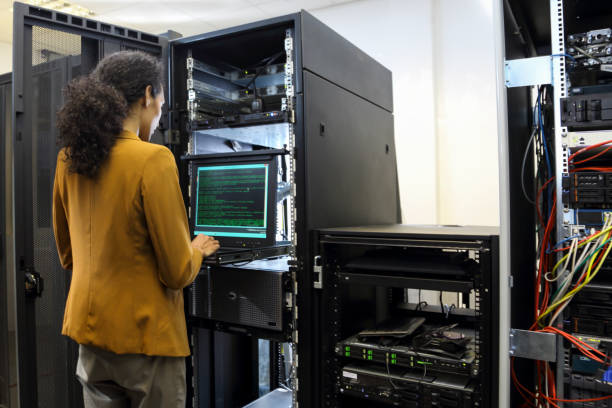 istock Female IT professional in server room 1304785885