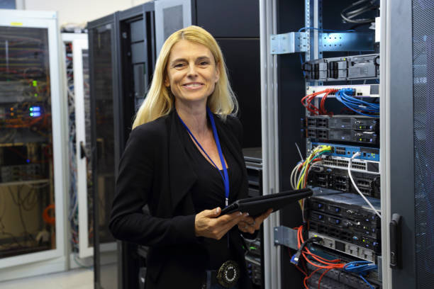 istock Female IT professional portrait in server room 1304785933