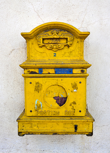 Budapest, Hungary - 2 September 2022: Vintage red postal box against yellow wall