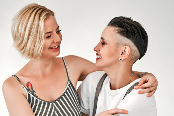 istock Cute lesbian couple shot in studio isolated on a white background. 1304793531