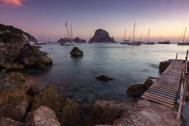 Sunset with view of Es Vedra from cala d'Hort in Ibiza (Spain) stock photo