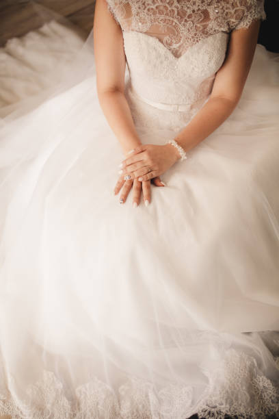 istock Bride hand on wedding dress. selective focus. wedding day 1304795480