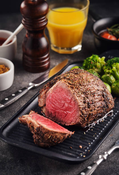 istock Roast beef on baking sheet with salt,  pepper and vegetables. 1304798884