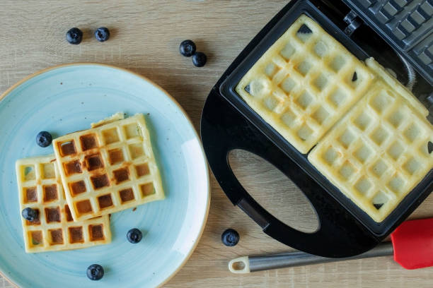 istock Waffles Being Baked in the Waffle Maker. Savory waffles. Breakfast concept 1304800984