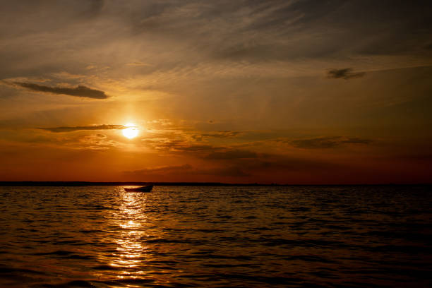 istock Beautiful sunset on the lake with clouds and reflections on the water 1304801029