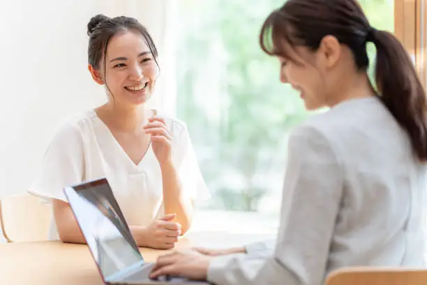 Photo of young japanese businesswoman meeting in the living room