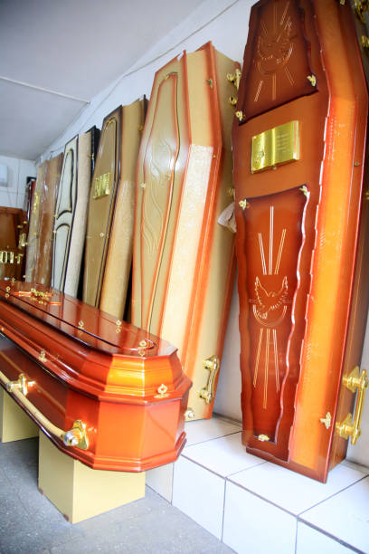 deceased coffin in funeral home salvador, bahia, brazil - february 19, 2021: a funeral home or coffin of the deceased are seen for sale in a funeral home in the city of Salvador. coffin crematorium stock pictures, royalty-free photos & images