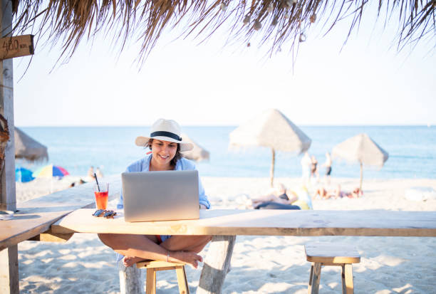 wireless technology on the beach. - on beach laptop working imagens e fotografias de stock