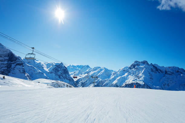 istock Ski lift over mountain peaks panorama and trails 1304804046