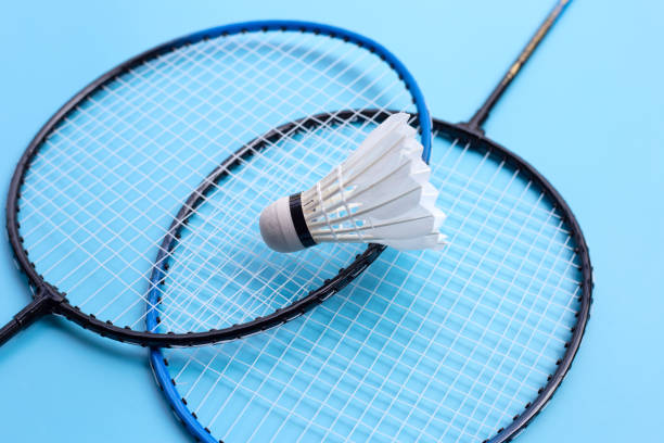 istock Shuttlecock and badminton rackets on blue background. 1304806072