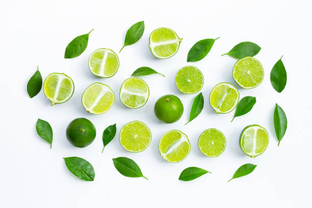 istock Fresh limes with green leaves on white background. 1304806125