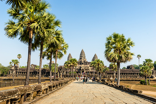 Angkor Wat, Cambodia - January 20, 2020: Crowd of tourists in front of Angkor Wat temple. The Angkor Wat is a Hindu temple complex in Cambodia and is the largest religious monument in the world.
