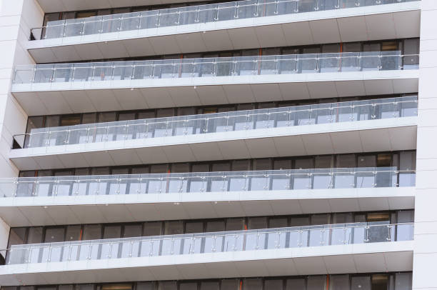 istock Apartment building block with glass balcony in row 1304811005