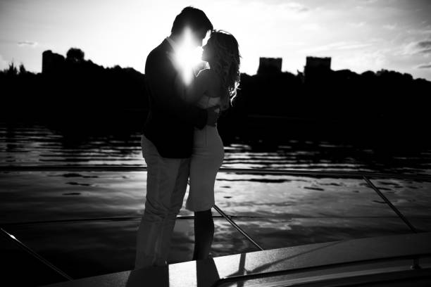 They pose by the Arno river, Ponte Vecchio in distance