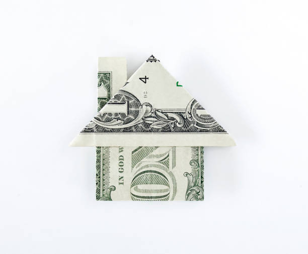 Origami dollar house Origami dollar house on top of dollar bills on white background money house stock pictures, royalty-free photos & images