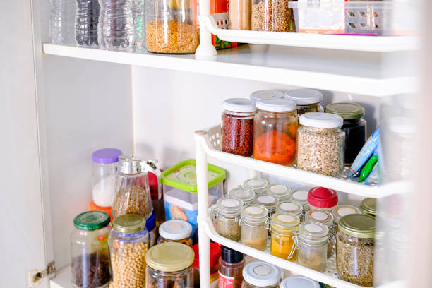 Well stocked pantry with a variety of pots and cans stock photo