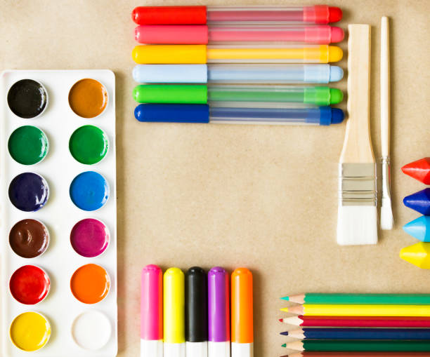 istock paints, felt-tip pens, brushes, crayons, markers, pencils lie on the table. Layout, top view 1304819338