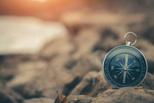 istock Compass of tourists on stone at riverside. 1304819567