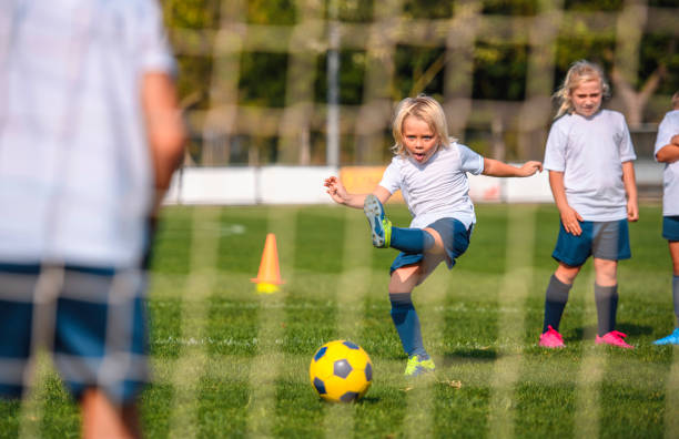 istock Focused 6 Year Old Footballer Practicing Goal Kick 1304821239