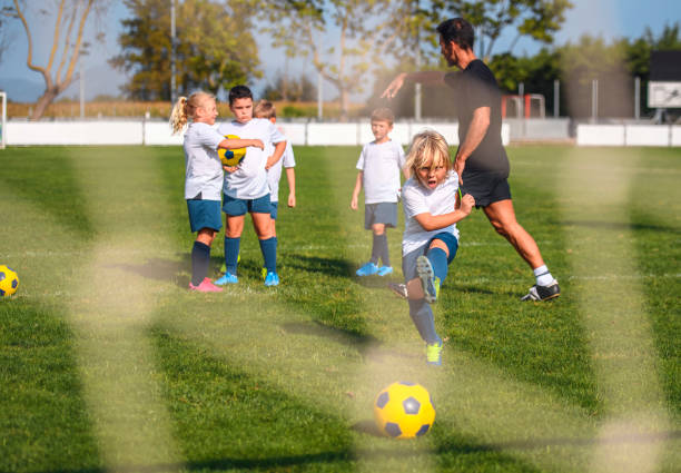 istock Determined Young Boy Footballer Practicing Goal Kick 1304821240