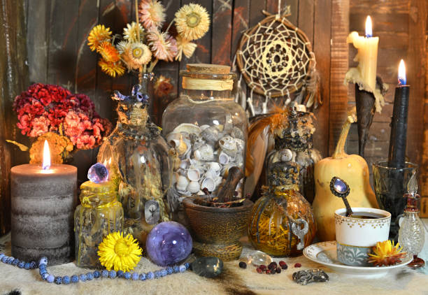 Still life with potion and elixir bottles, burning candles and magic ritual objects on witch table. Still life with potion and elixir bottles, burning candles and magic ritual objects on witch table. Esoteric, gothic and occult background, Halloween mystic concept. potion bottle retro revival old fashioned stock pictures, royalty-free photos & images